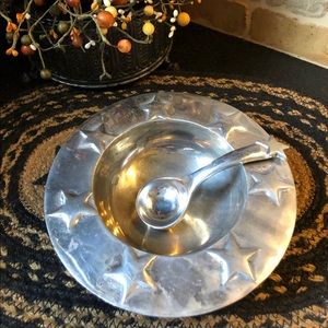 Handcrafted silver serving bowl and ladle.